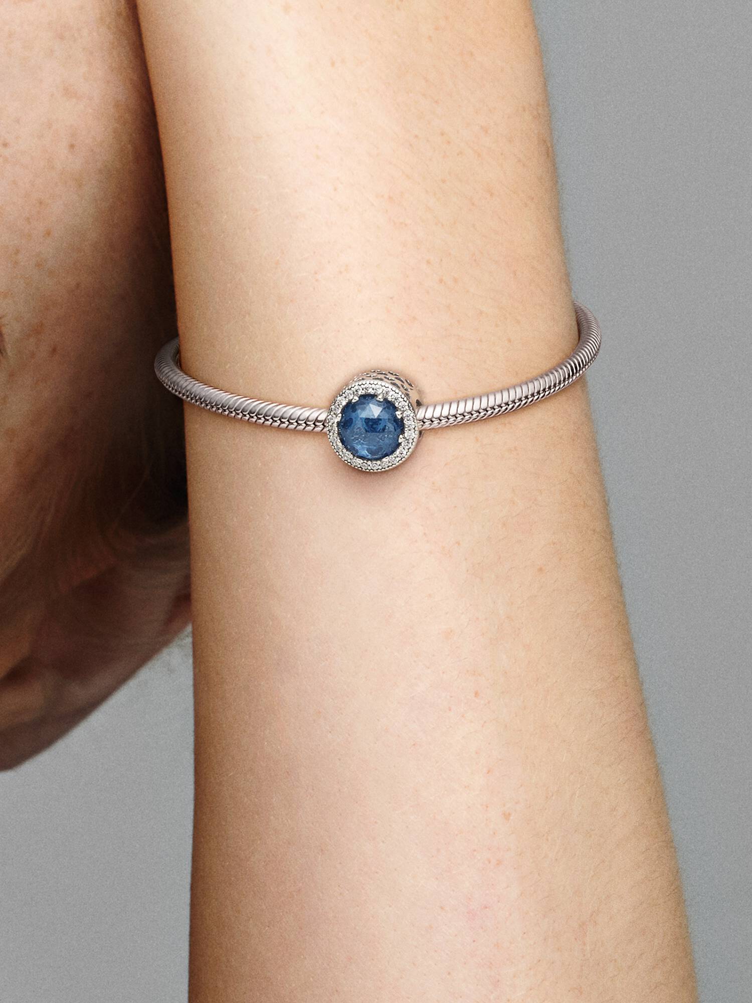 Abstract silver charm with moonlight blue crystal and clear cubic zirconia
